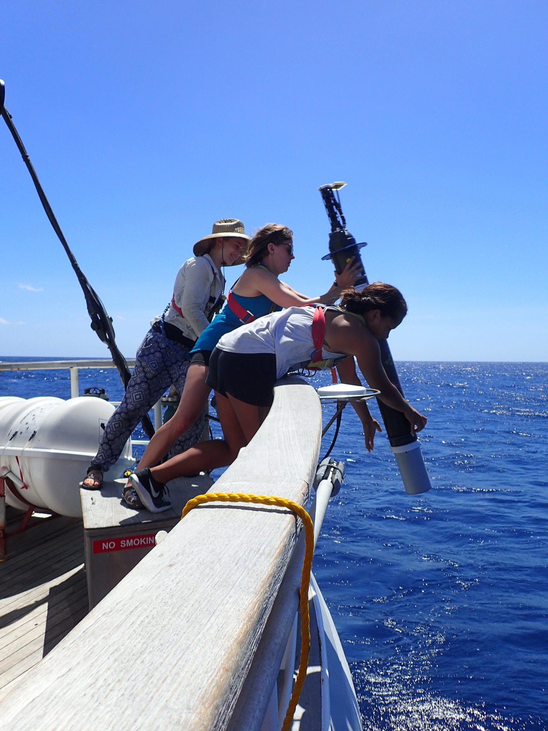 ASCC Student Intern Deploying Instrument In The Ocean.