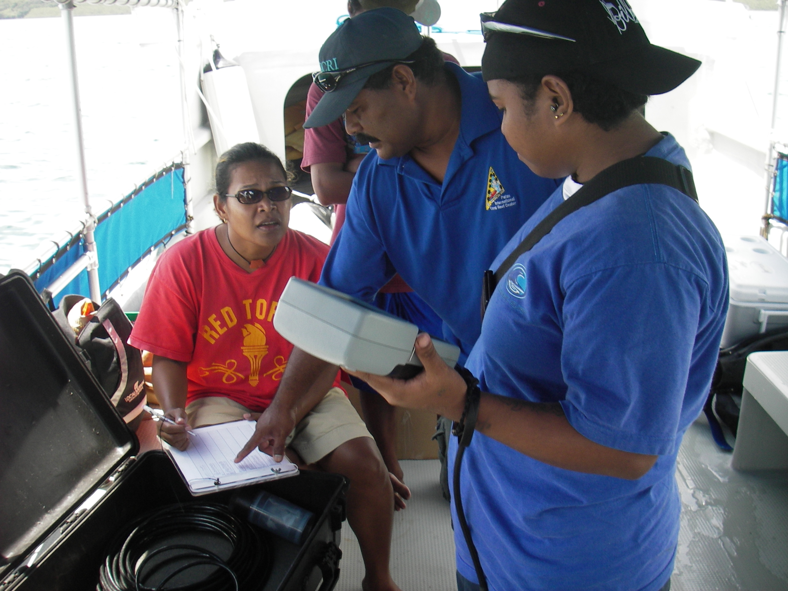 PCC Marine Science Student Discusses Results On The YSI Sonde With His Instructors.