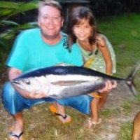 Marine Science Instructor, Brian Lynch, is pictured holding a fish with his young daughter.